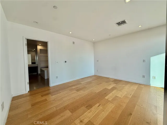 a view of a room with wooden floor and windows
