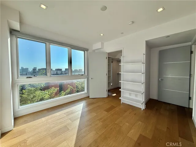 a view of walk in closet with empty racks