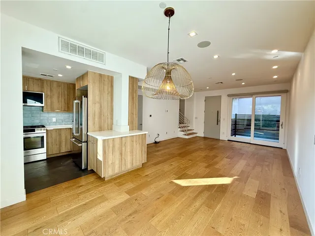 a kitchen with stainless steel appliances a stove sink microwave and refrigerator