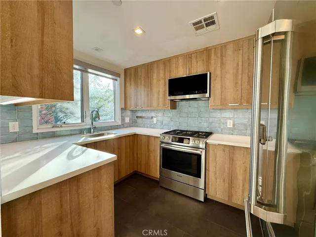 a kitchen with a stove and a refrigerator