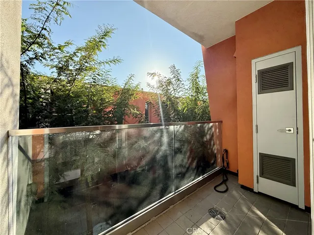 a view of balcony with wooden floor and fence