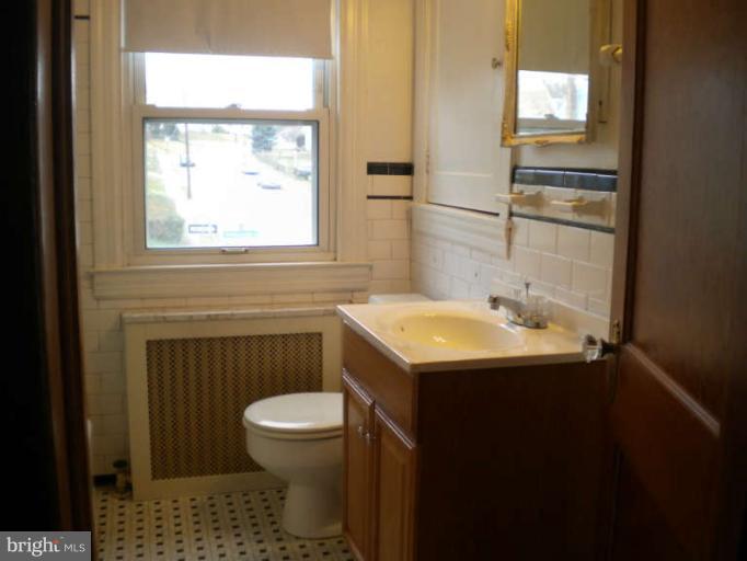 5527 Ashbourne Road Halethorpe, MD 21227 - Photo 13 of 30 a bathroom with a sink a toilet and a window