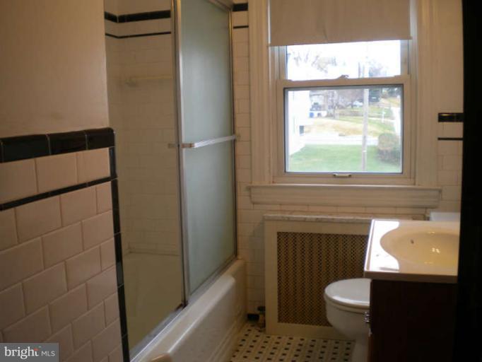 5527 Ashbourne Road Halethorpe, MD 21227 - Photo 14 of 30 a bathroom with a sink toilet and shower