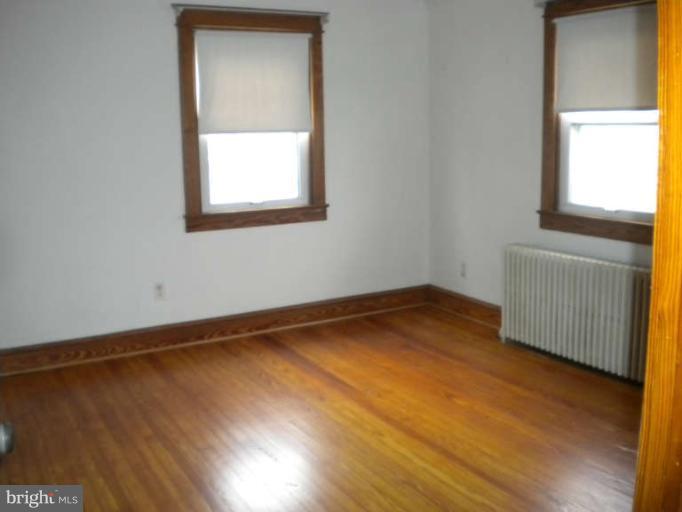 5527 Ashbourne Road Halethorpe, MD 21227 - Photo 15 of 30 a view of an empty room with wooden floor and a window
