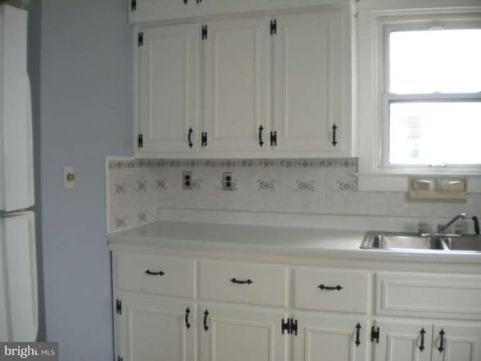 5527 Ashbourne Road Halethorpe, MD 21227 - Photo 8 of 30 a view of white cabinets with a sink
