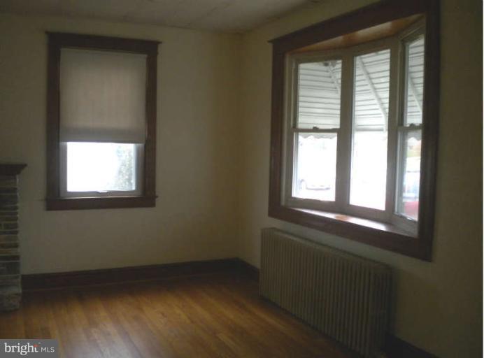 5527 Ashbourne Road Halethorpe, MD 21227 - Photo 10 of 30 a view of an empty room with wooden floor and a window