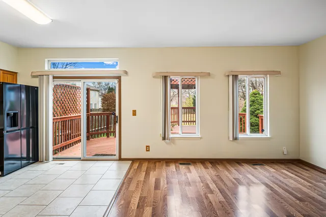 a view of an empty room with glass door and balcony