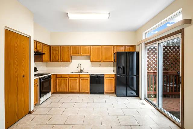 a kitchen with stainless steel appliances granite countertop a refrigerator and a sink