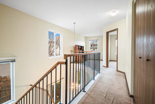 a view of a hallway with windows and stairs