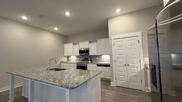 a kitchen with refrigerator and cabinets