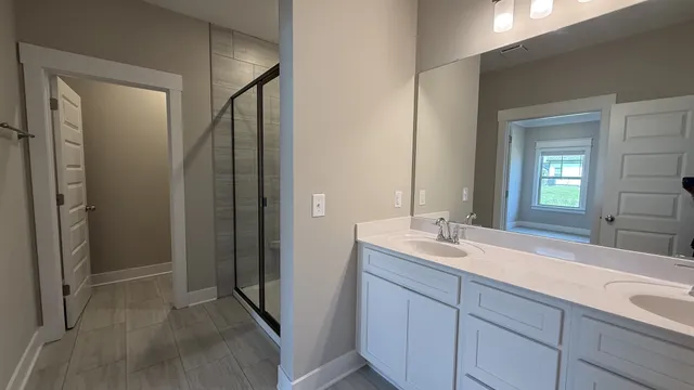 an empty room with wooden floor and mirror