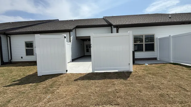 a view of a house with a wooden fence