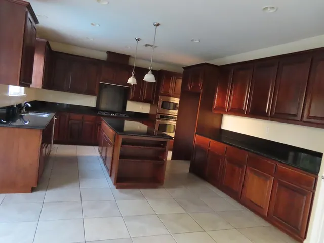 a kitchen with cabinets and chairs