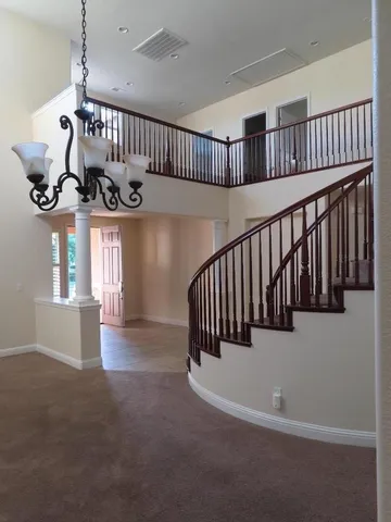 a view of staircase and kitchen with stainless steel appliances