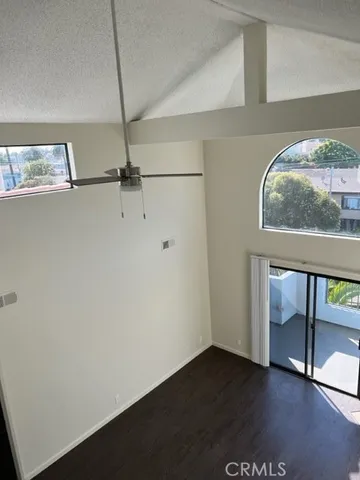 a view of room with window and wooden floor