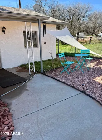 a view of a house with a yard and potted plants