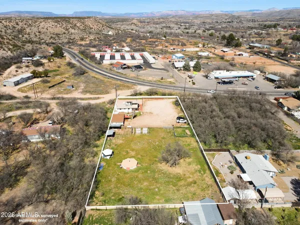 an aerial view of residential houses with yard