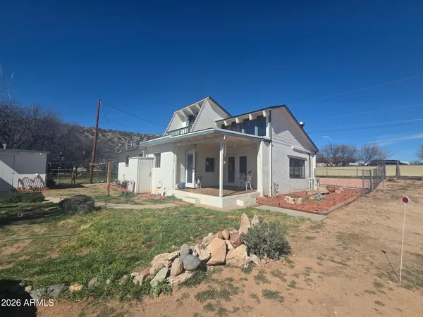 a view of a house with backyard and porch