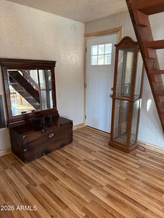a view of a room with wooden floor