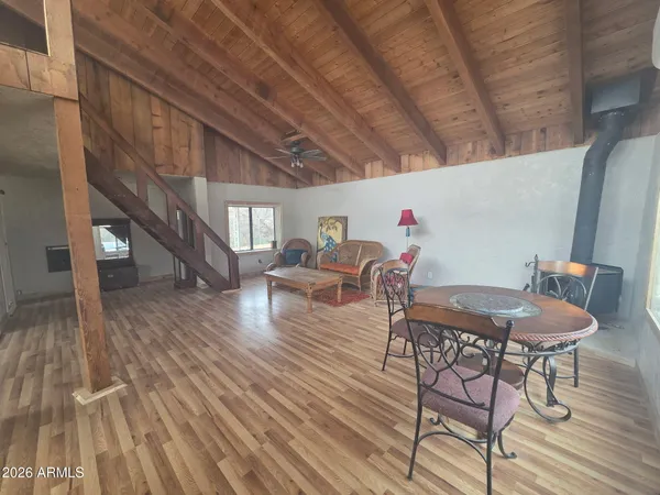 a dining room with furniture entryway and wooden floor