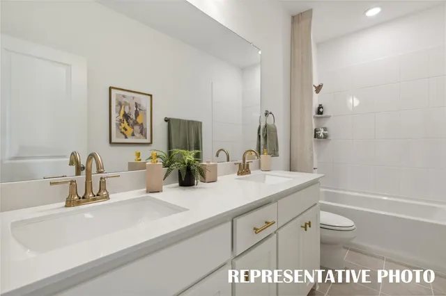 a bathroom with a double vanity sink and a mirror