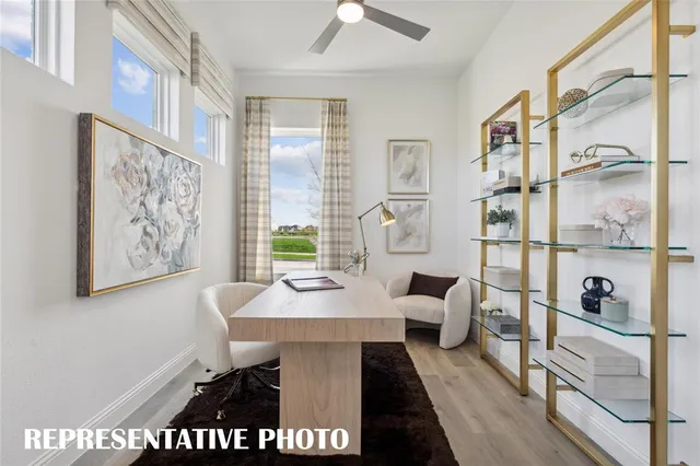 a living room with furniture large window and wooden floor