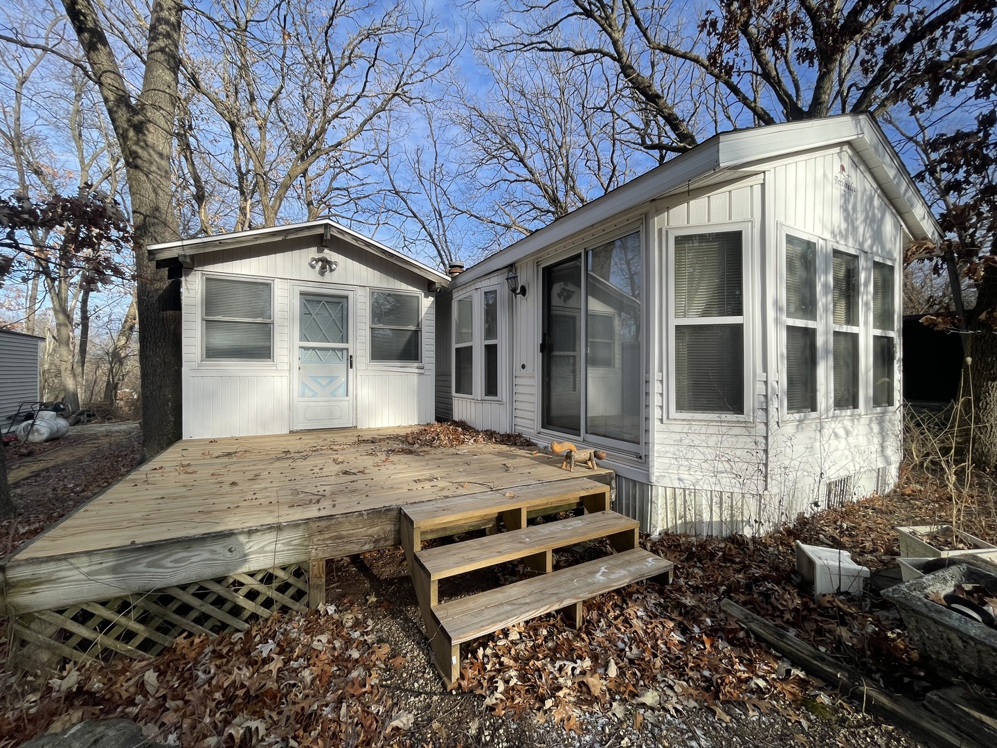 26-204 Woodhaven Lakes Sublette, IL 61367 - Photo 2 of 17 a front view of a house with a garden