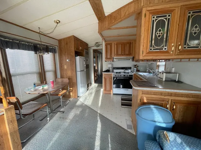 a kitchen with a sink appliances and cabinets