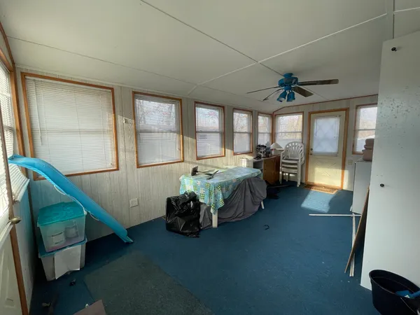 a bedroom with furniture and a large window