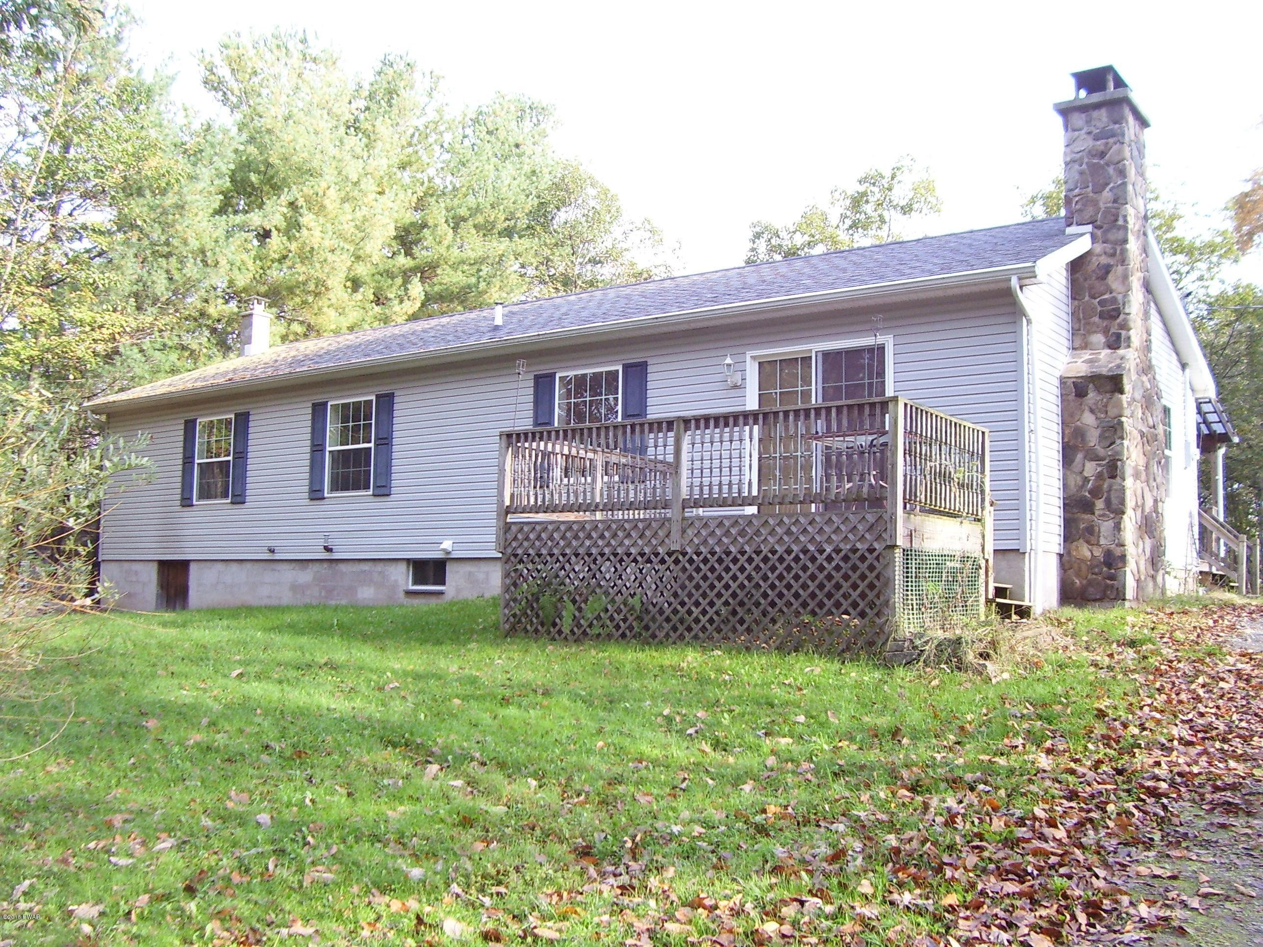 13 W Road Hawley, PA 18428 - Photo 1 of 26 a front view of a house with a garden