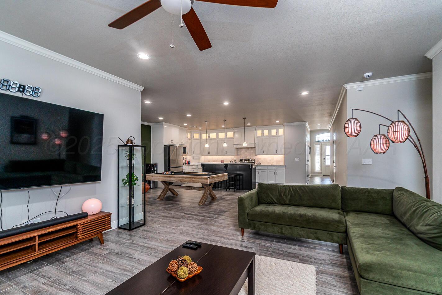 7500 Crestline Drive Amarillo, TX 79119 - Photo 13 of 24 a living room with furniture and a flat screen tv