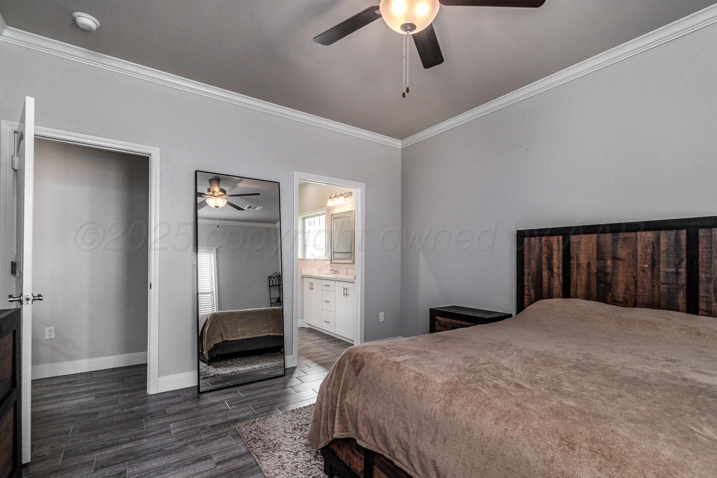 7500 Crestline Drive Amarillo, TX 79119 - Photo 15 of 24 a bedroom with a bed and a chandelier