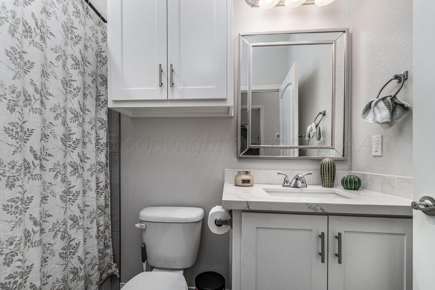 7500 Crestline Drive Amarillo, TX 79119 - Photo 19 of 24 a bathroom with a toilet sink and mirror