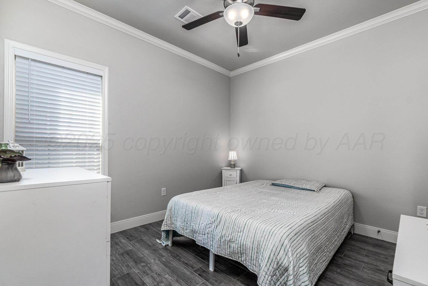 7500 Crestline Drive Amarillo, TX 79119 - Photo 20 of 24 a bedroom with a bed and a window
