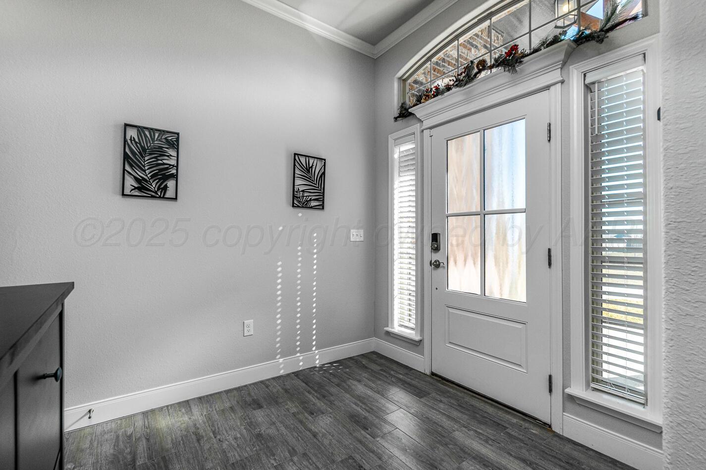 7500 Crestline Drive Amarillo, TX 79119 - Photo 3 of 24 an empty room with wooden floor and windows