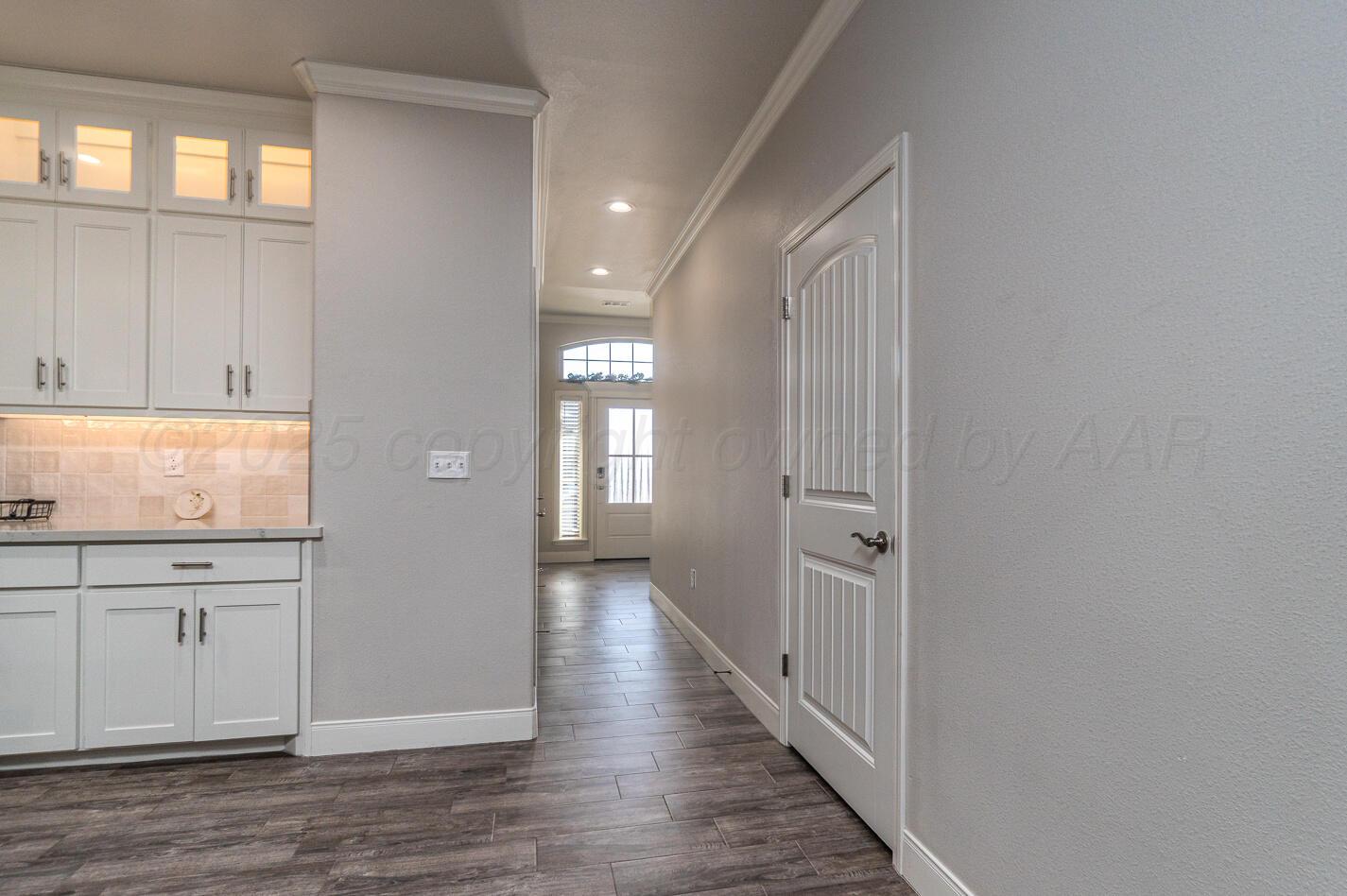 7500 Crestline Drive Amarillo, TX 79119 - Photo 4 of 24 a view of a hallway with wooden floor and closet