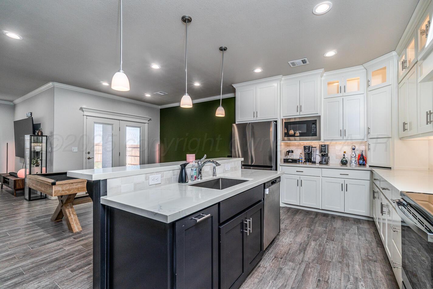 7500 Crestline Drive Amarillo, TX 79119 - Photo 7 of 24 a kitchen with kitchen island granite countertop lots of counter top space and stainless steel appliances