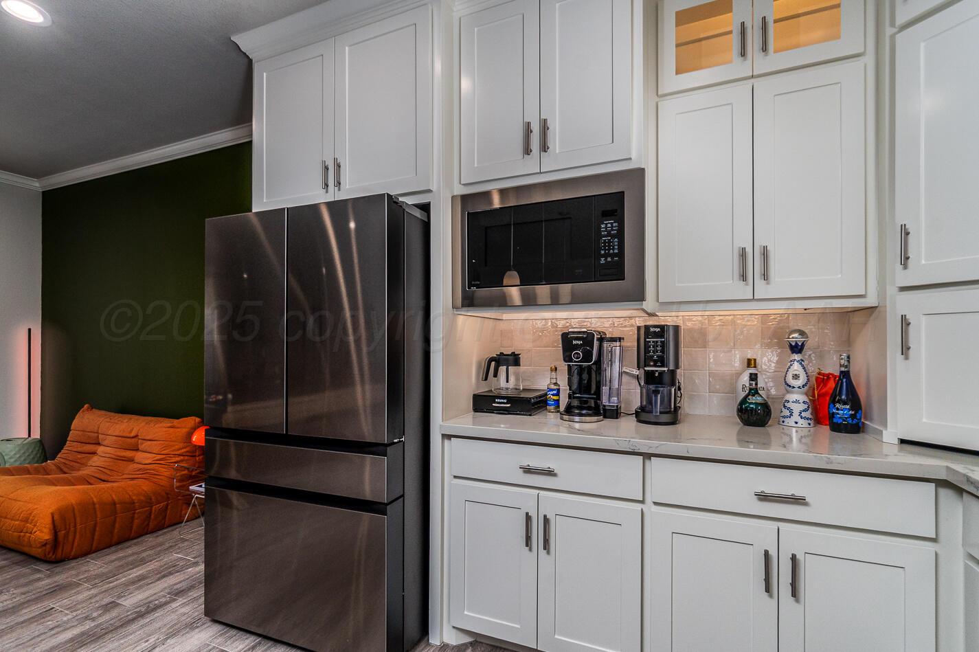 7500 Crestline Drive Amarillo, TX 79119 - Photo 8 of 24 a kitchen with stainless steel appliances white cabinets and a refrigerator
