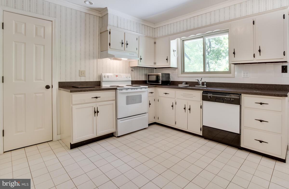 2645 Aspen Road Port Republic, MD 20676 - Photo 17 of 51 a kitchen with cabinets appliances a sink and a window
