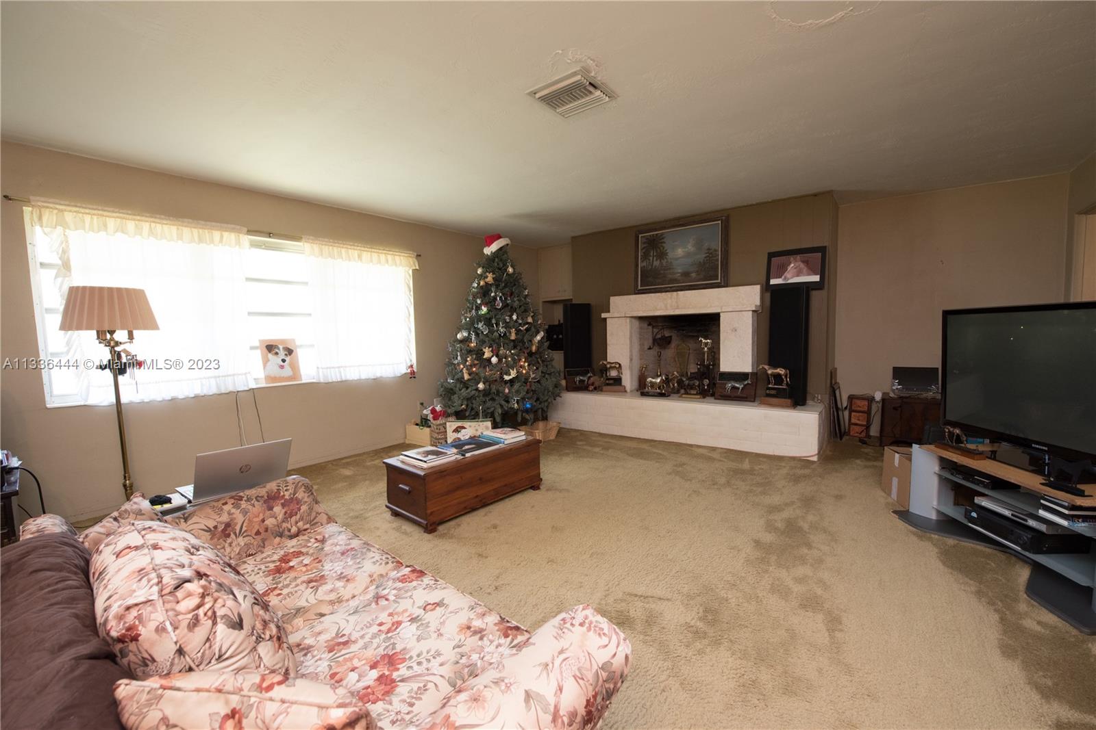 Redlands Homestead, FL 33031 - Photo 16 of 35 a living room with furniture flat screen tv and a fireplace