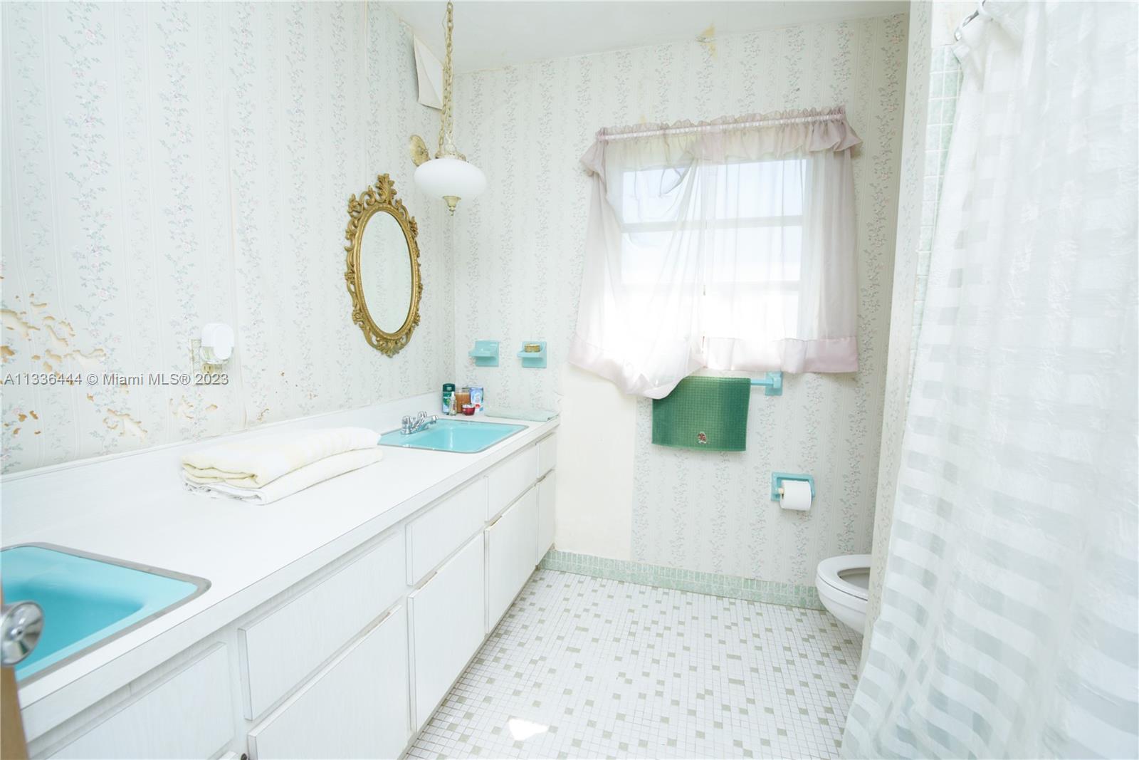 Redlands Homestead, FL 33031 - Photo 18 of 35 a bathroom with a granite countertop sink a toilet and a mirror