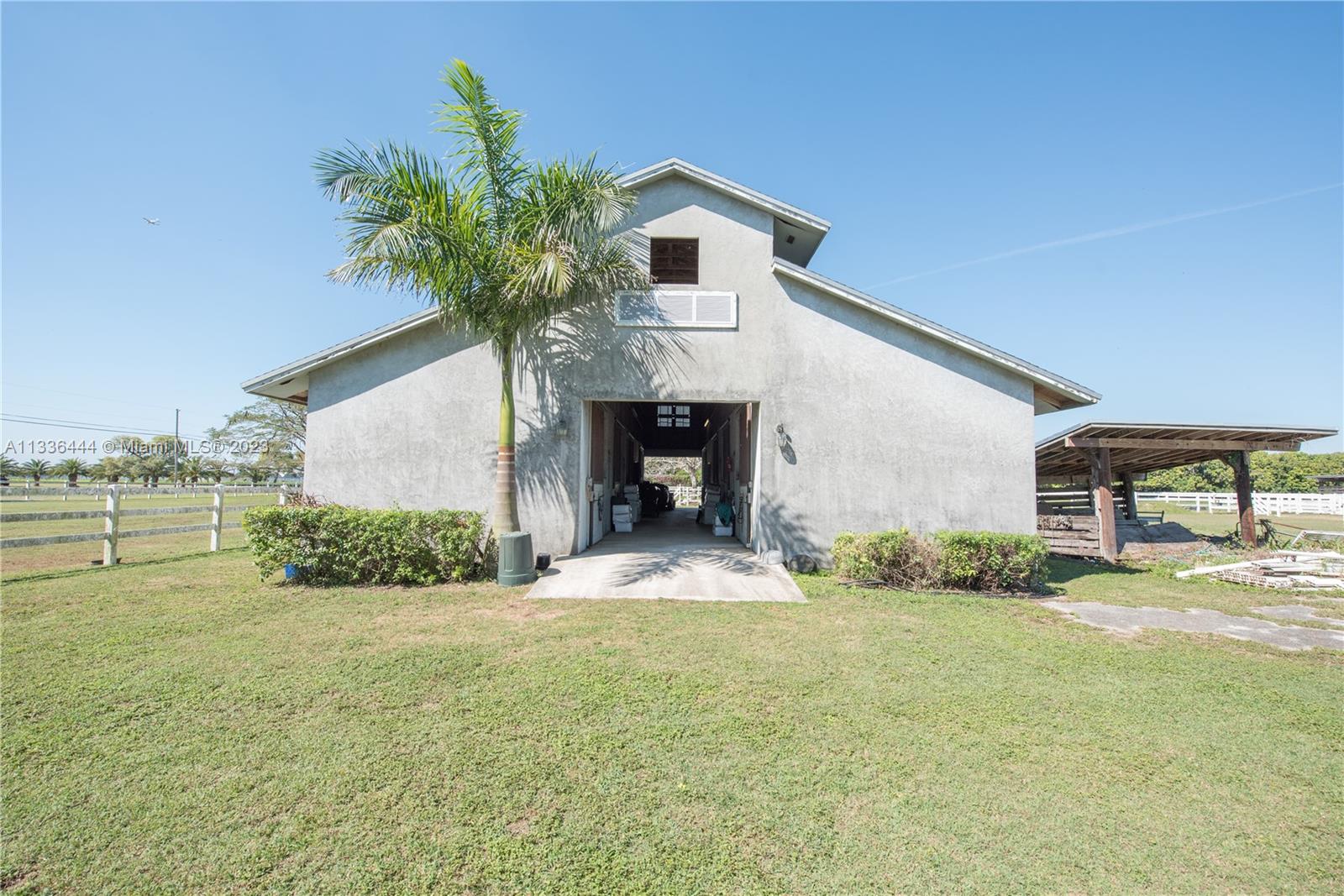 Redlands Homestead, FL 33031 - Photo 29 of 35 a front view of a house with a yard and garage
