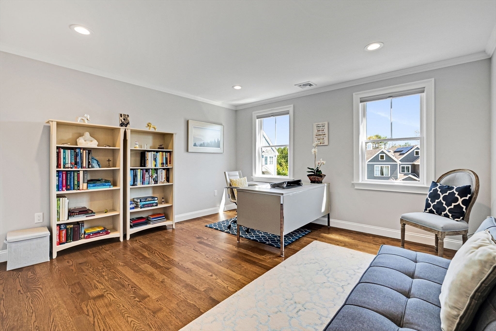 17 Sunrise Terrace Needham, MA 02492 - Photo 24 of 42 a living room with furniture and a book shelf
