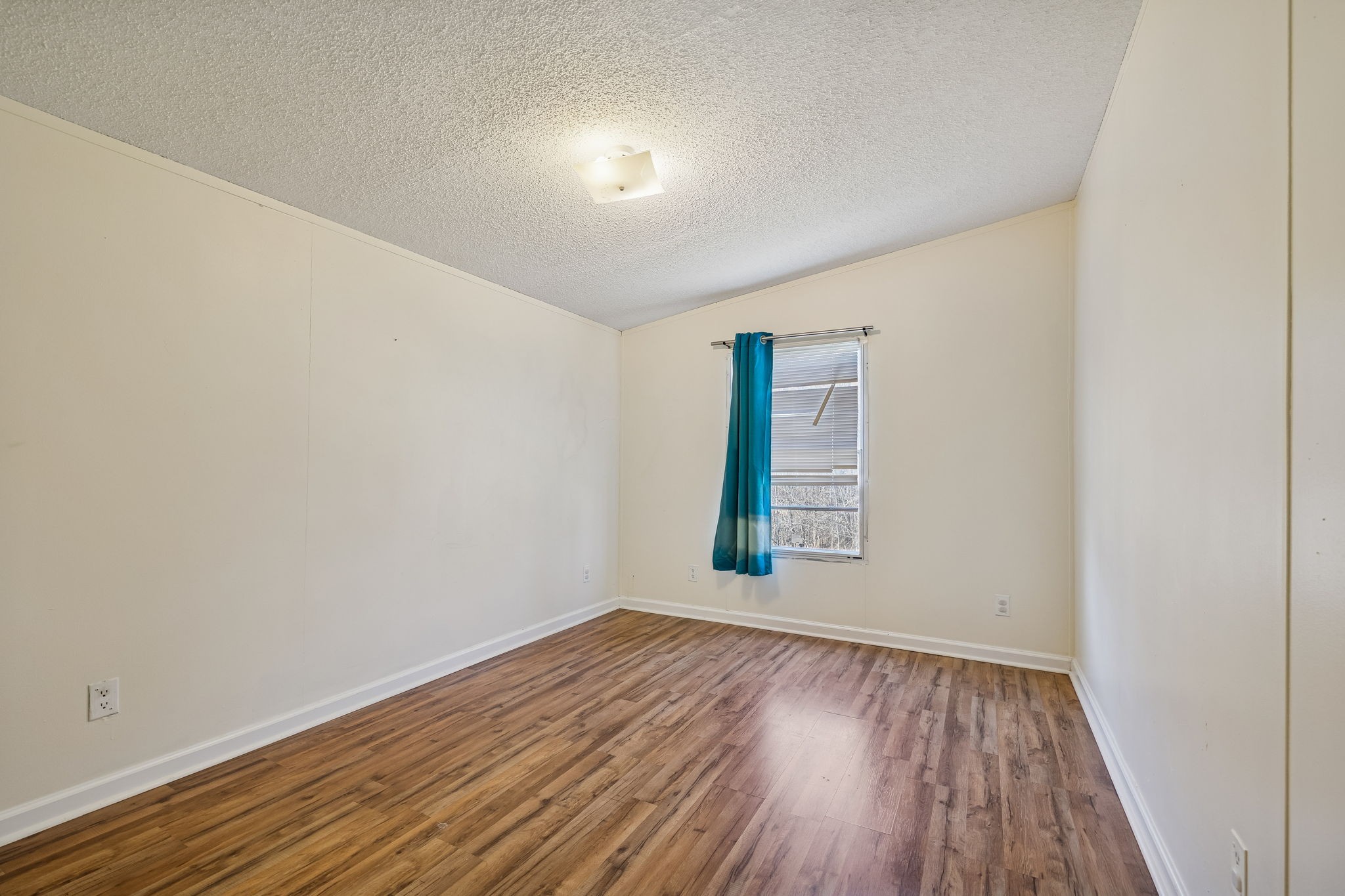 217 Tomlinson Road Lebanon, TN 37087 - Photo 16 of 23 an empty room with wooden floor and windows
