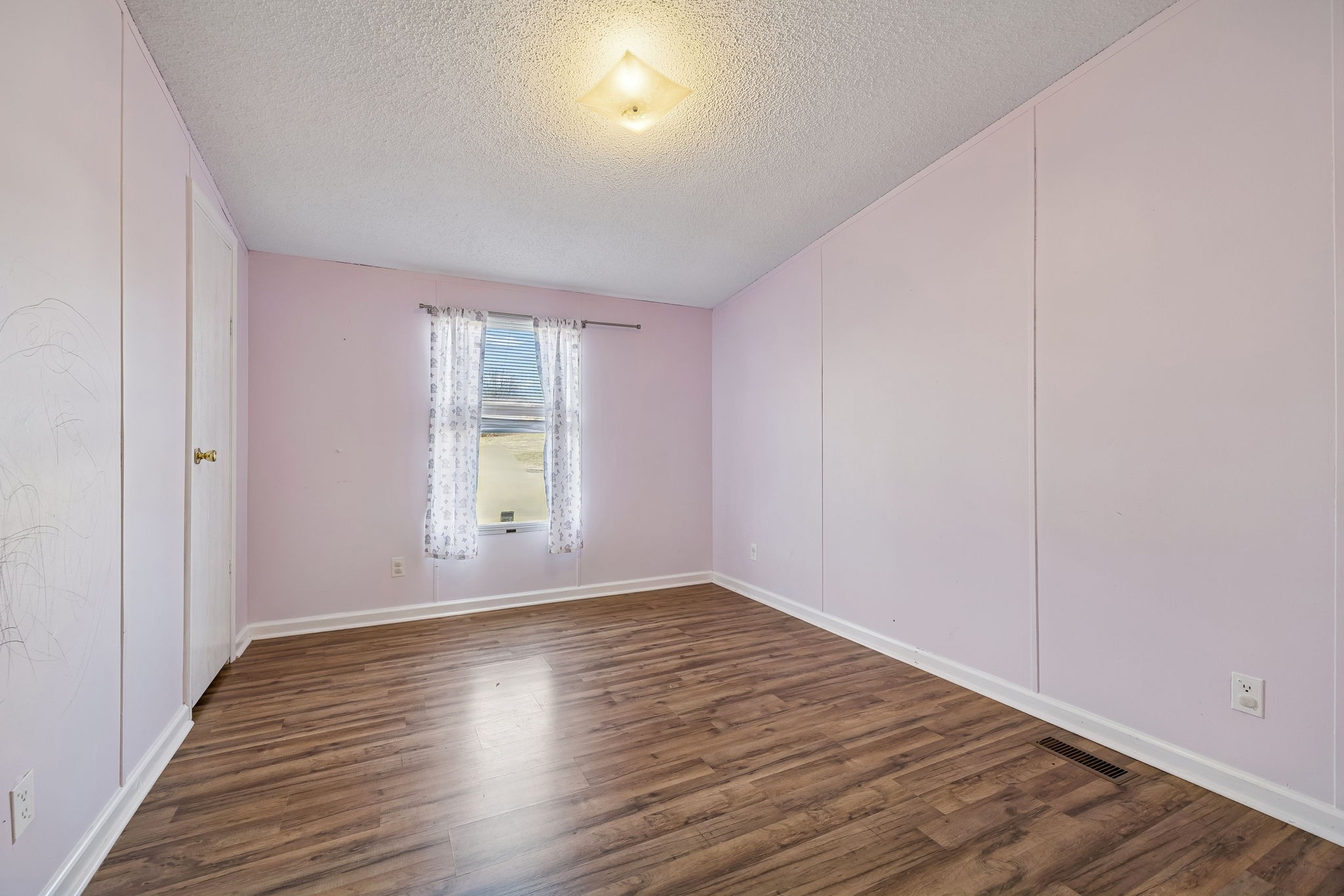 217 Tomlinson Road Lebanon, TN 37087 - Photo 18 of 23 wooden floor in an empty room with a window