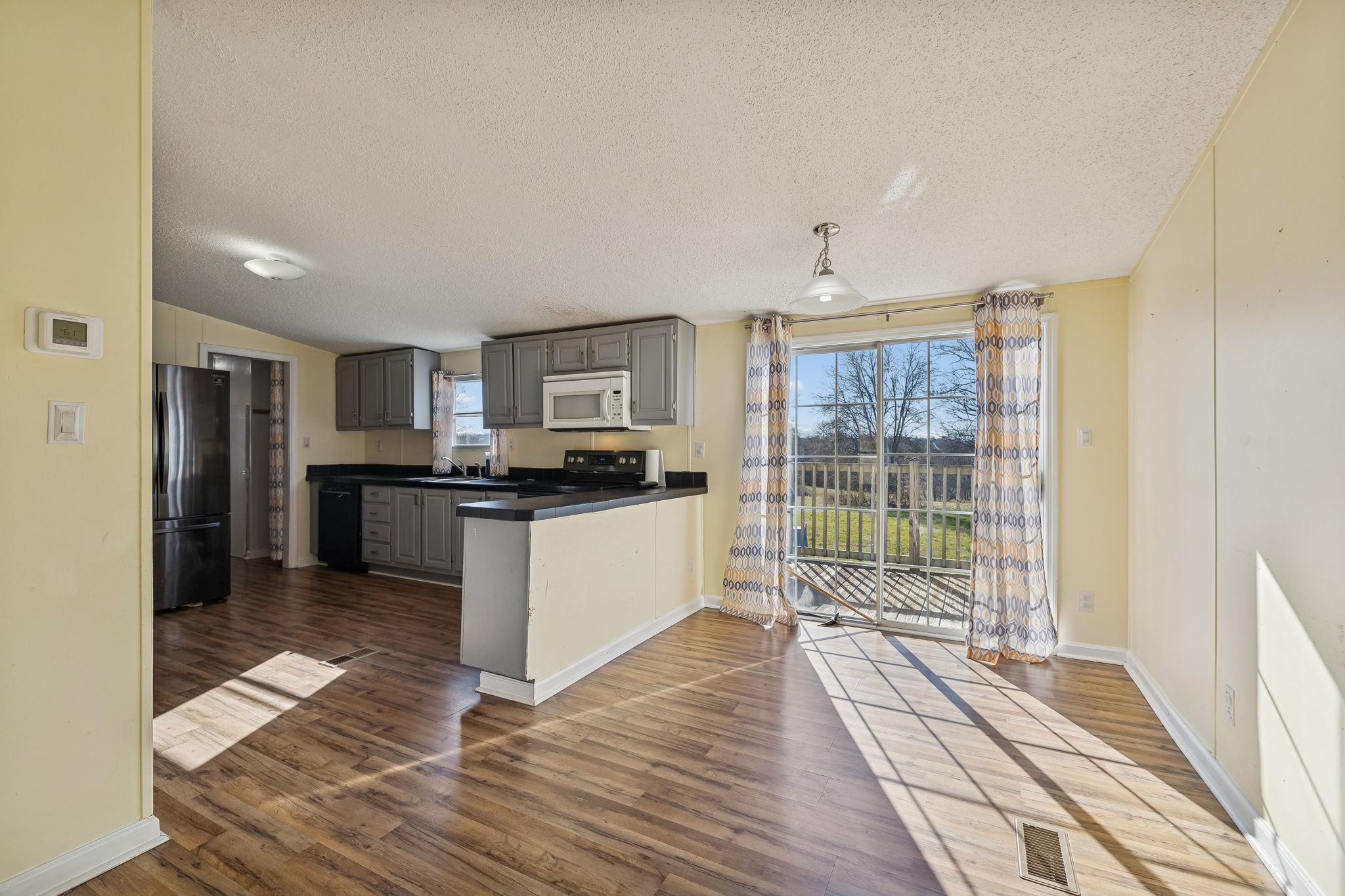 217 Tomlinson Road Lebanon, TN 37087 - Photo 7 of 23 a kitchen with stainless steel appliances kitchen island granite countertop a refrigerator and a sink
