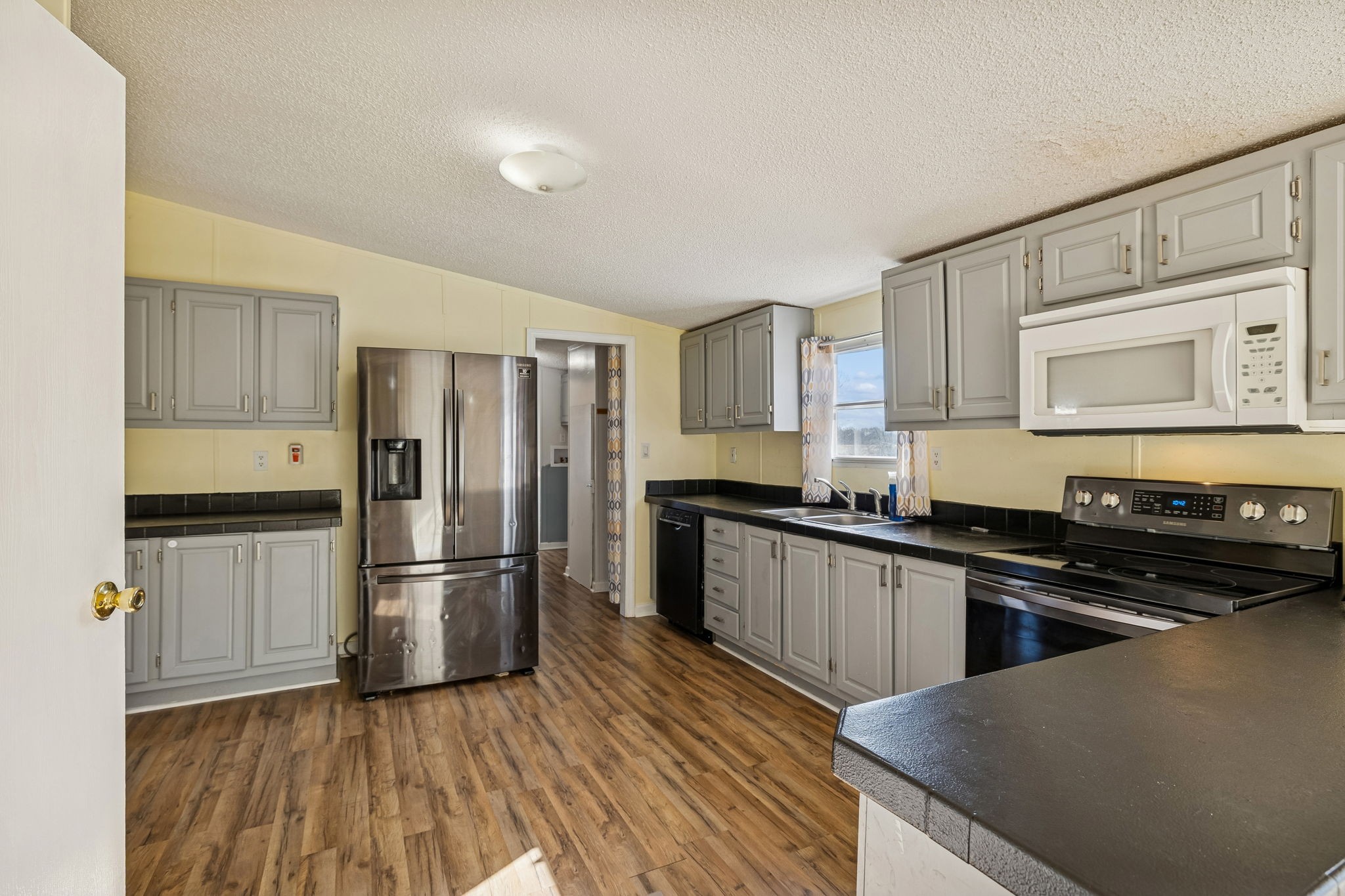 217 Tomlinson Road Lebanon, TN 37087 - Photo 8 of 23 a kitchen with a refrigerator stove and wooden cabinets