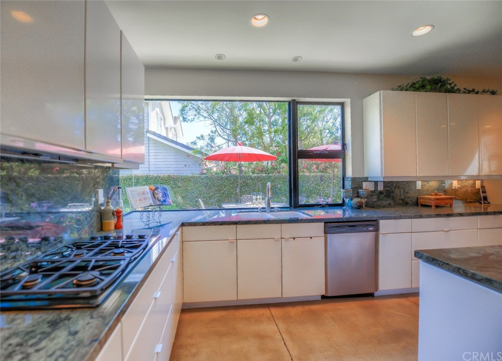 2831 Ridge Drive Laguna Beach, CA 92651 - Photo 17 of 49 a kitchen with stainless steel appliances granite countertop a stove a sink and a microwave