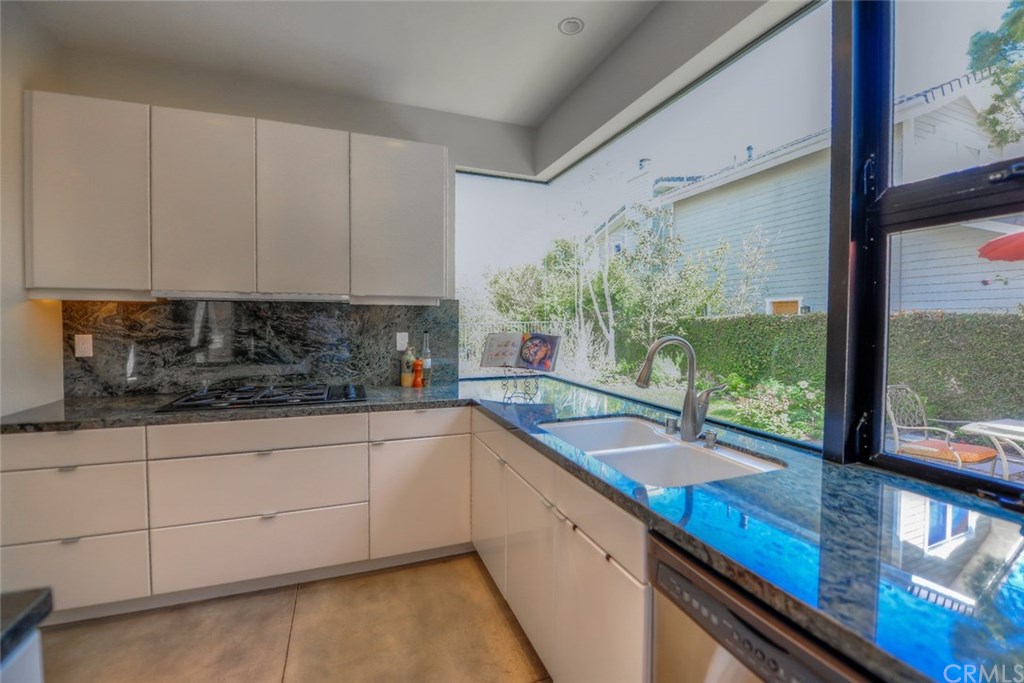 2831 Ridge Drive Laguna Beach, CA 92651 - Photo 18 of 49 a kitchen with granite countertop a sink and white cabinets