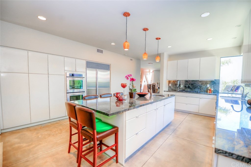 2831 Ridge Drive Laguna Beach, CA 92651 - Photo 19 of 49 a kitchen with stainless steel appliances kitchen island granite countertop a sink and cabinets